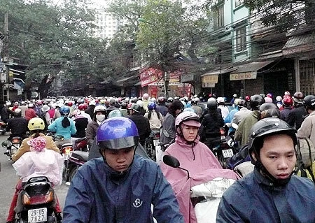 Không khó để bắt gặp những người đi người chiều trong những đám tắc đường ở Hà Nội.Ảnh:Xuân Tùng