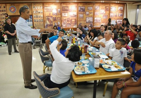 US President Barack Obama chats with a family while greeting military personnel and their families at a mess hall at Marine Base Hawaii at Kaneohe Bay on Christmas Day, December 25, 2011. Obama greeted base personnel while vacationing at a rental home nearby US President Barack Obama chats with a family while greeting military personnel and their families at a mess hall at Marine Base Hawaii at Kaneohe Bay on Christmas Day, December 25, 2011. Obama greeted base personnel while vacationing at a rental home nearby