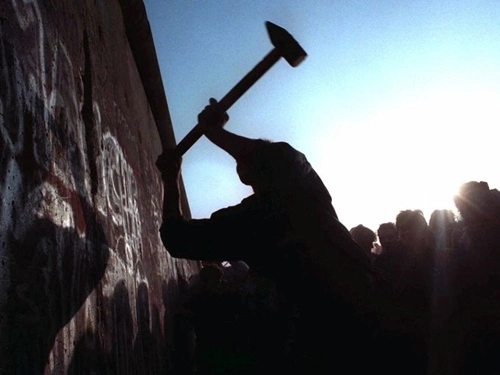 A man hammers away at the Berlin Wall Nov. 12, 1989, as the border barrier between East and West Germany was torn down after 28 years, symbolically ending the Cold War.