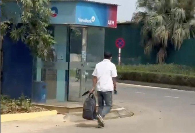 Hình ảnh nghi phạm xách balo nghi có tiền cướp được, đi bộ rời ngân hàng. Ảnh: Cắt từ video