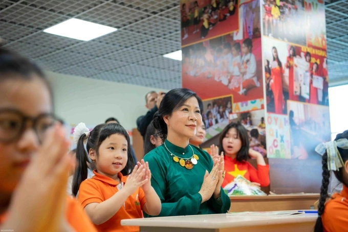 Phu nhân Ngô Phương Ly cùng các em học sinh thưởng thức tiết mục văn nghệ. Ảnh: Báo Quốc tế