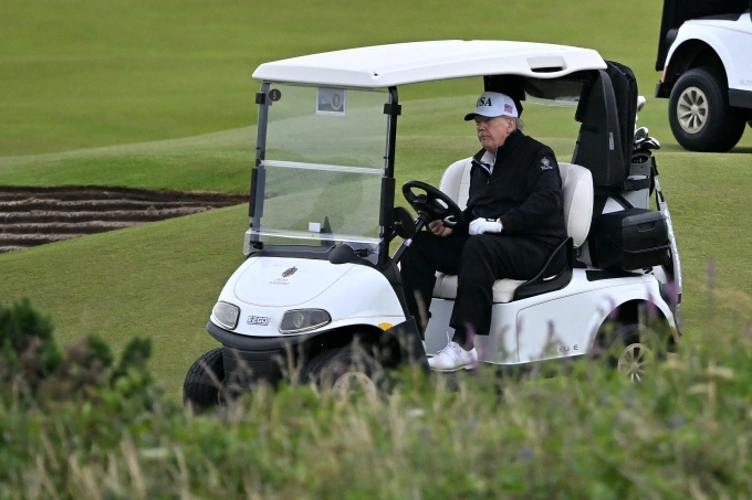 US President Donald Trump drives a golf buggy as he plays golf at the Trump Turnberry Golf Courses, in Turnberry on the south west coast of Scotland on July 27, 2025, during the third day of his visit to the country, since his second tenure as President began.