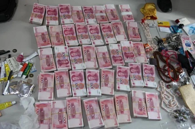 Lượng lớn tiền mặt được cảnh sát tìm thấy trong nhà Vương Hưng Phu. Ảnh: QQ