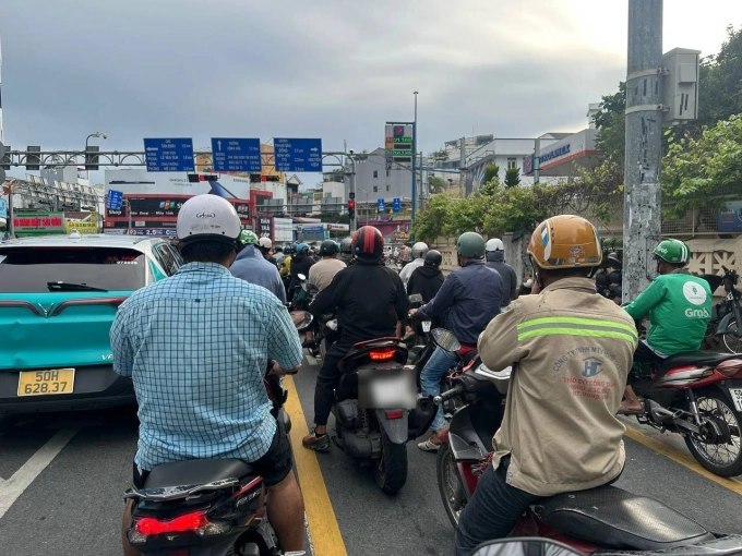 Xe máy dừng đèn đỏ ở làn có kẻ vạch mắt võng làm người muốn rẽ phải dồn ứ. Ảnh: An Phương