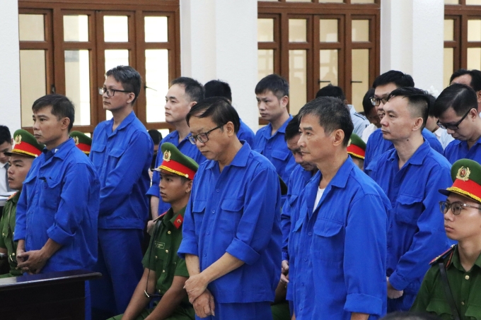 Ông Trần Ngọc Linh (mang kính đứng giữa) cùng các bị cáo nghe tuyên án, sáng 26/9. Ảnh: Khải Nguyên