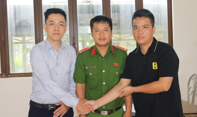 Anh Lê Ngọc Khải (trái) chuyển trả số tiền cho anh Bùi Văn Bắc tại cơ quan công an. Ảnh: Phước Thanh