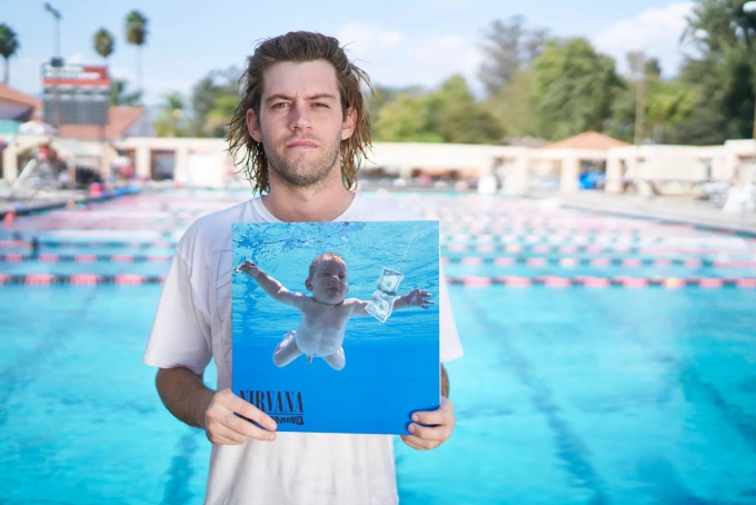 Spencer Elden cầm bìa album huyền thoại Nevermind của ban nhạc Nirvana, sử dụng hình ảnh của chính anh khi mới 4 tháng tuổi. Ảnh: NYT