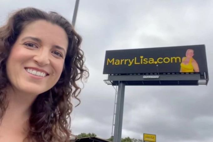 Lisa Catalano chụp selfie cùng biển quảng cáo của mình ở San Francisco. Ảnh: SFC