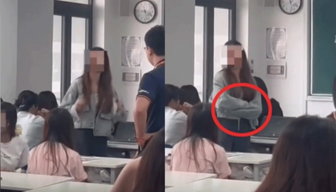 Nữ sinh khoanh tay, tranh cãi với thầy giáo khi bị mời ra khỏi lớp. Ảnh cắt từ video
