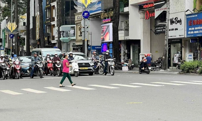 Người đi bộ đang sang đường tại một giao lộ ở TP HCM. Ảnh: Hồ Tân