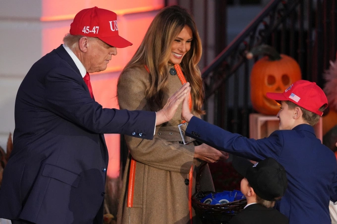 Tổng thống Mỹ Donald Trump đập tay với cậu bé hóa trang thành ông trong tiệc Halloween tại Nhà Trắng ngày 30/10. Ảnh: AP