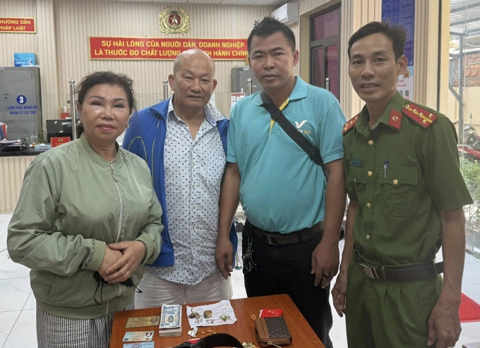 Cảnh sát và tài xế làm thủ tục trả lại tài sản. Ảnh: Công an TP HCM