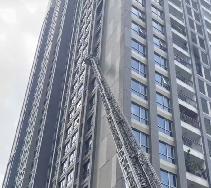 Lính cứu hỏa giương thang cao gần 15 m để tiếp cận căn hộ cháy dập lửa. Ảnh: Minh Bằng