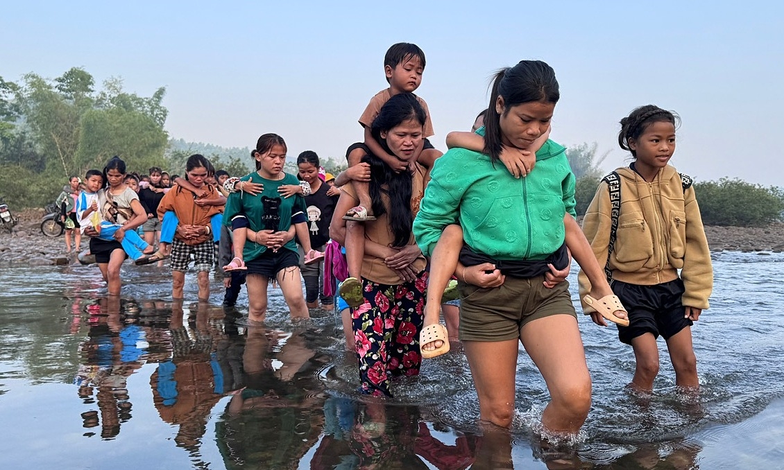 Phụ huynh cõng con lội sông đến lớp