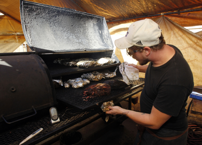 Nhân viên kiểm tra máy hun khói tại cửa hàng BBQ Stillwater ở Abilene, Texas, tháng 12/2014. Ảnh: Reuters