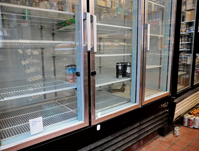 Tủ lạnh trống trơn bên trong một cửa hàng rượu bia ở trung tâm Boston, ngày 15/6. Ảnh: Boston Globe