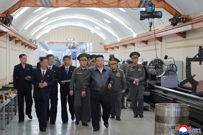 Lãnh đạo Triều Tiên Kim Jong-un cùng các quan chức thị sát nhà máy sản xuất đạn dược tại một địa điểm không được tiết lộ vào ngày 11/5. Ảnh: KCNA