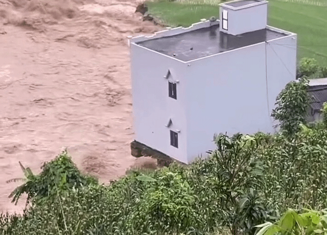 Floodwaters swallow two-story house in Vietnam minutes after family of 6 escapes