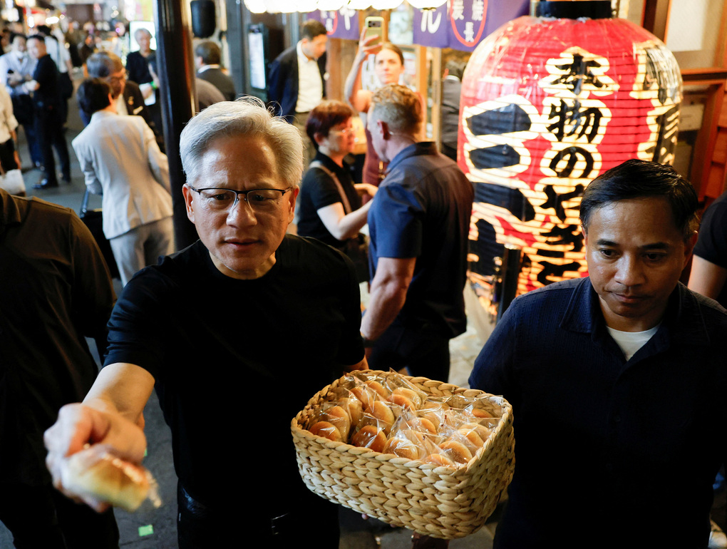 Nvidia CEO Jensen Huang hands out dumplings in Tokyo. Photo: Reuters