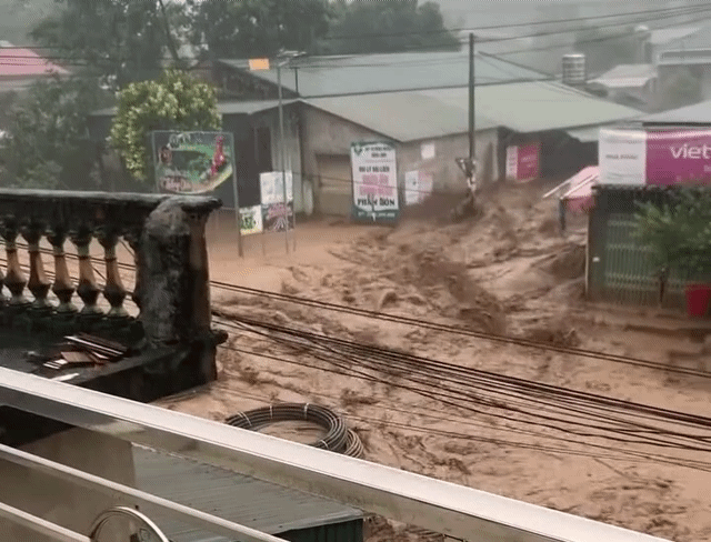 Muddy floodwater swallows mountain highway in Vietnam